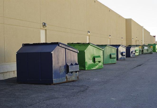 a yellow construction dumpster filled with waste materials in Doerun, GA